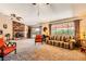 Relaxing living room featuring a fireplace, large window, and comfortable furnishings at 1950 Abarth St, Las Vegas, NV 89142