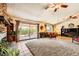 A sprawling living room features a brick fireplace, neutral carpet and ample light, with a covered outdoor space at 1950 Abarth St, Las Vegas, NV 89142