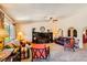 Spacious living room with a ceiling fan, carpet flooring, and arched doorways at 1950 Abarth St, Las Vegas, NV 89142