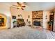A living room displaying a brick fireplace and neutral colored carpet at 1950 Abarth St, Las Vegas, NV 89142