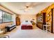 A bright main bedroom showcases a large window and comfortable carpet at 1950 Abarth St, Las Vegas, NV 89142