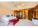 The spacious main bedroom has neutral carpet and wood paneling at 1950 Abarth St, Las Vegas, NV 89142