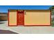 A yellow shed with a red door is on the concrete slab at 1950 Abarth St, Las Vegas, NV 89142