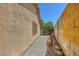Side yard with textured wall, rock landscaping, and possible storage space at 1950 Abarth St, Las Vegas, NV 89142