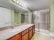 Bathroom features a double sink vanity with granite countertops and walk-in shower at 2212 Sunfish Dr # C, Henderson, NV 89014