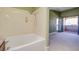 Bathroom with soaking tub and shower combination along with a view to the balcony at 2212 Sunfish Dr # C, Henderson, NV 89014