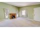 Cozy living room with a brick fireplace, carpet floors, and windows for natural light at 2212 Sunfish Dr # C, Henderson, NV 89014