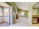 Open-concept living room with a fireplace, balcony access, and view into the kitchen at 2212 Sunfish Dr # C, Henderson, NV 89014