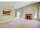 Open living room with cozy fireplace and arched view into kitchen at 2212 Sunfish Dr # C, Henderson, NV 89014