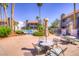 Inviting community pool area with lounge chairs, tables, and umbrellas amidst lush landscaping at 2212 Sunfish Dr # C, Henderson, NV 89014