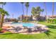 Community pool surrounded by palm trees and lush landscaping provides a resort-like atmosphere at 2212 Sunfish Dr # C, Henderson, NV 89014