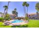 Sparkling community pool surrounded by lush greenery and lounge chairs at 2212 Sunfish Dr # C, Henderson, NV 89014