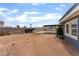 Large backyard with brick fence, carport, and potential for landscaping and outdoor activities at 2301 Maverick St, Las Vegas, NV 89108