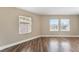 Cozy bedroom with wood-look flooring and natural light from three large windows at 2301 Maverick St, Las Vegas, NV 89108
