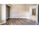 Bedroom with wood-look flooring, closet, and an open doorway leading to another room at 2301 Maverick St, Las Vegas, NV 89108