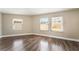 Bedroom with wood-look flooring and natural light from three large windows at 2301 Maverick St, Las Vegas, NV 89108