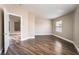 Bright bedroom with wood-look flooring and view of an adjacent room through an open door at 2301 Maverick St, Las Vegas, NV 89108