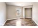 This bedroom features wood-look floors, a window, and a spacious closet at 2301 Maverick St, Las Vegas, NV 89108