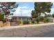 Charming single-story home with mature trees, and well-maintained yard and chain link fence at 2301 Maverick St, Las Vegas, NV 89108