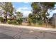 Charming single-story home with mature trees and a well-maintained front yard and chain link fence at 2301 Maverick St, Las Vegas, NV 89108