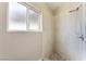 Tiled shower stall featuring a shower head and a window letting in natural light at 2301 Maverick St, Las Vegas, NV 89108