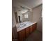 Bright bathroom has a double sink vanity, tile floor, and large mirror with lighting at 2604 Webster St, North Las Vegas, NV 89030