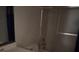 Bathroom features a tub shower with sliding glass door and a single sink vanity at 2604 Webster St, North Las Vegas, NV 89030
