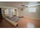 Bright bedroom boasts hardwood floors, a ceiling fan, and closet with sliding mirror doors at 2604 Webster St, North Las Vegas, NV 89030