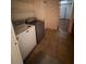 Laundry room features a washer and dryer, tiled floor, and overhead shelving at 2604 Webster St, North Las Vegas, NV 89030