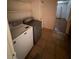Laundry room features a washer and dryer, tiled floor, and overhead shelving at 2604 Webster St, North Las Vegas, NV 89030