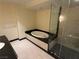 This bathroom has a jacuzzi tub, glass enclosed shower, and light colored tiled floors at 2700 Las Vegas Blvd # 2811, Las Vegas, NV 89109