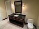 Bathroom featuring a dark wood vanity with granite countertop, tiled floors, and a toilet at 2700 Las Vegas Blvd # 2811, Las Vegas, NV 89109