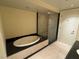 Bathroom featuring a jacuzzi tub, glass enclosed shower, and tiled floors at 2700 Las Vegas Blvd # 2811, Las Vegas, NV 89109