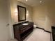 Bathroom featuring a dark wood vanity with granite countertop and tiled floors at 2700 Las Vegas Blvd # 2811, Las Vegas, NV 89109