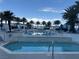 Resort-style swimming pool area with palm trees, lounge chairs, and cascading water features at 2700 Las Vegas Blvd # 2811, Las Vegas, NV 89109