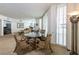 Elegant dining area featuring a round glass-top table and decorative chairs near large windows at 2877 Paradise Rd # 906, Las Vegas, NV 89109