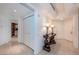 Bright hallway with tiled floors and elegant console table with lamps, leading to various rooms at 2877 Paradise Rd # 906, Las Vegas, NV 89109