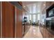 Modern kitchen with wooden cabinetry, stainless steel appliances, and a cozy breakfast nook at 2877 Paradise Rd # 906, Las Vegas, NV 89109