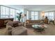 Bright living room featuring comfortable seating, decorative plants, and elegant glass tables at 2877 Paradise Rd # 906, Las Vegas, NV 89109