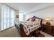 Comfortable main bedroom with a large decorative bed, side table, and bright windows at 2877 Paradise Rd # 906, Las Vegas, NV 89109