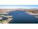 This aerial view showcases a community with a large lake, golf course, and mountain views at 30 Hilltop Crest St, Henderson, NV 89011