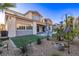 The backyard features artificial turf, a splash pool, and desert landscaping with small palm trees at 30 Hilltop Crest St, Henderson, NV 89011