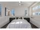 Bright bedroom featuring hardwood floors, plantation shutters, and stylish decor at 30 Hilltop Crest St, Henderson, NV 89011