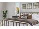 Comfortable bedroom with a large bed, decorative pillows, and natural light from the window at 30 Hilltop Crest St, Henderson, NV 89011