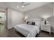 Modern bedroom featuring a ceiling fan, wood floors, and a comfortable king-sized bed at 30 Hilltop Crest St, Henderson, NV 89011