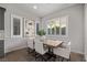 Bright dining area with large windows, plantation shutters, and a contemporary table set for six at 30 Hilltop Crest St, Henderson, NV 89011
