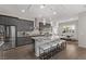 Modern kitchen with stainless steel appliances, granite countertops, stylish pendant lighting, and island seating at 30 Hilltop Crest St, Henderson, NV 89011