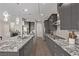 Spacious kitchen with a granite island, stainless steel appliances, and designer lighting at 30 Hilltop Crest St, Henderson, NV 89011