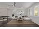 Open-concept living room with a white sofa, jute rug, and a contemporary ceiling fan at 30 Hilltop Crest St, Henderson, NV 89011