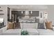 Stylish living room with modern gray kitchen in the background, and a white sectional sofa at 30 Hilltop Crest St, Henderson, NV 89011